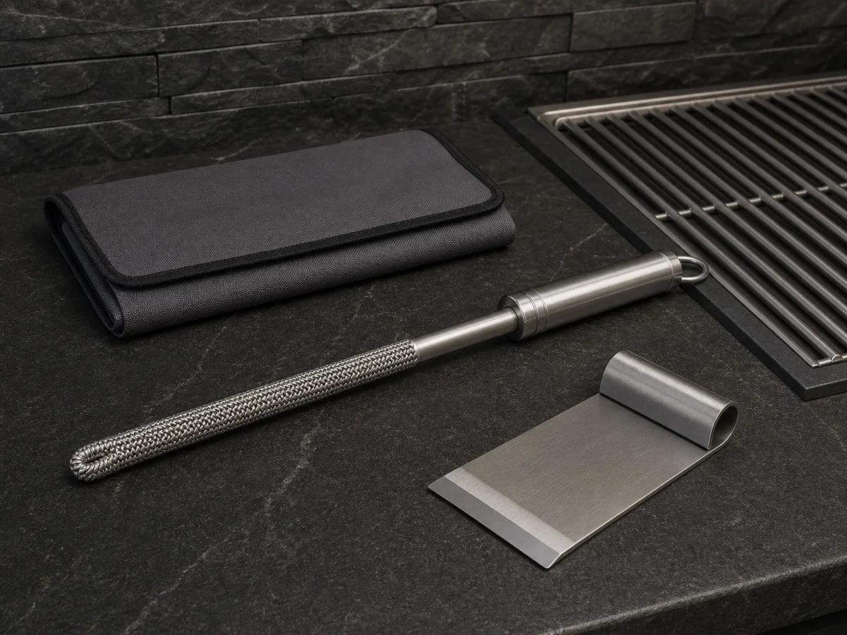 Bristle-free coil brush, flat scraper, and storage sleeve on a cleanup surface
